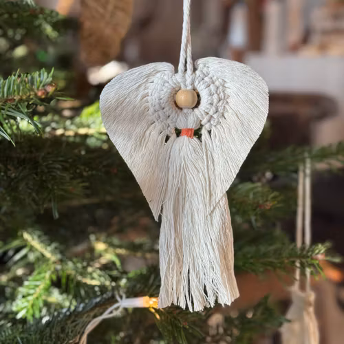 Deco av en ängel med rött band