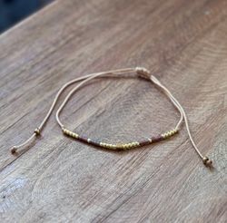 Armband guld/brunlila skimmer