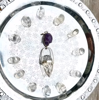 Master of the skulls  Master dragon amethyst skull with clear quartz dragon egg, and 12 high frequency clear quartz skulls.