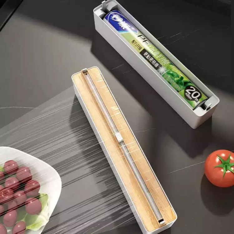 Plastic foil dispenser with sliding cutter
