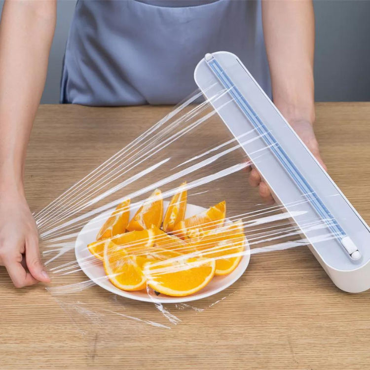 Plastic foil dispenser with sliding cutter