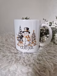 Snögubbe med paket och texten God Jul
