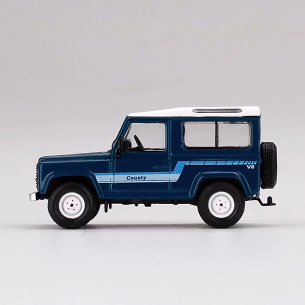 Skala 1/64 Land Rover Defender 90 County Wagon, Stratos Blue fr MINI GT