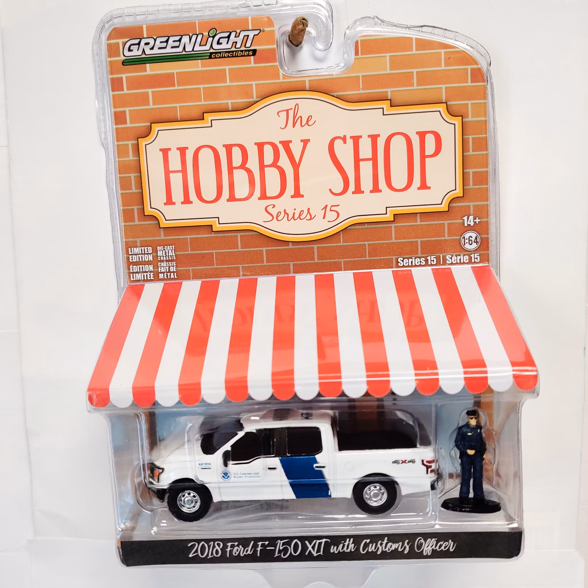 Skala 1/64 Greenlight "The Hobby Shop" 2018 Ford F-150 XLT w Officer