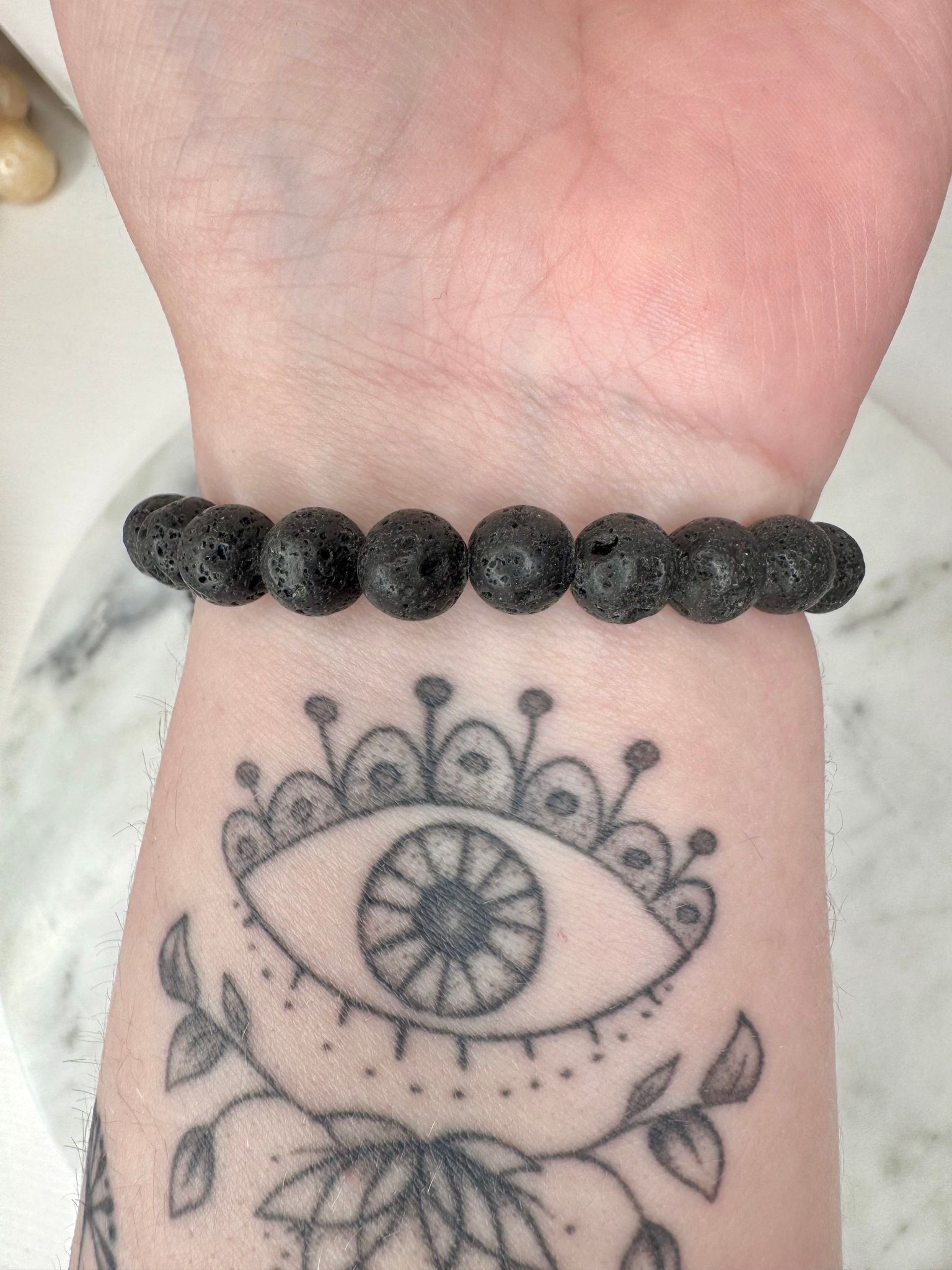 Lavastens armband runt handled eye tatoo