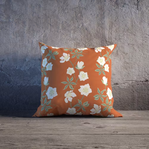 Belle Helle på stugvärme, Helleborus julrosen på orange kuddfodral
