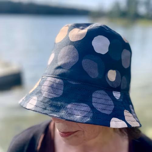 en "sassy n swag"-hatt med det bredaste brättet i mönstret Chestnutty, med kastanjer på svart