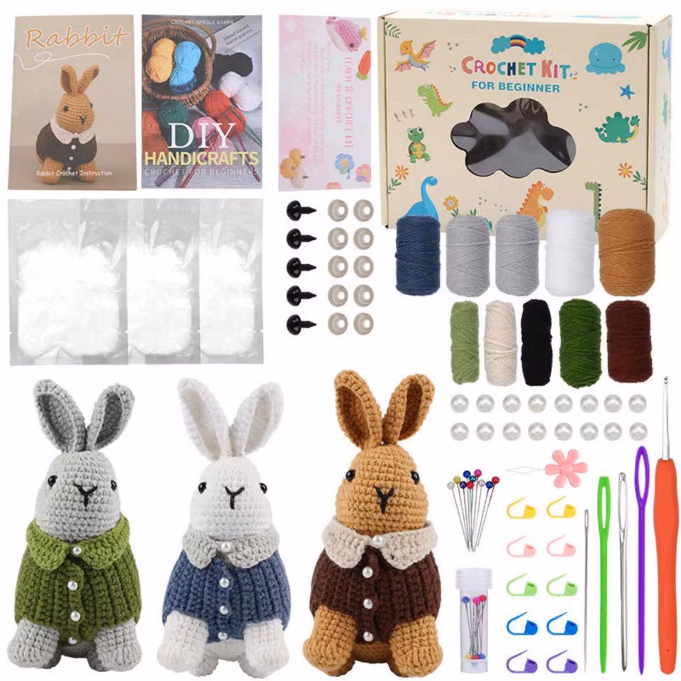 DIY virkset för nybörjare – skapa tre virkade kanindockor med garn, ögon, nålar och enkla instruktioner. Perfekt kreativ present.