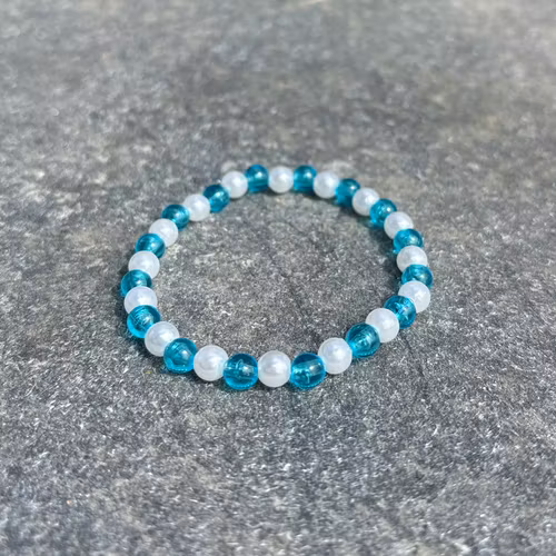 Turkosblå och vit armband med akrylpärlor