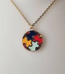Guldfärgat halsband med en rund pusselbit, berlock / charm