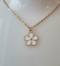 Guldfärgat halsband med en vit blomma, blomberlock / charm