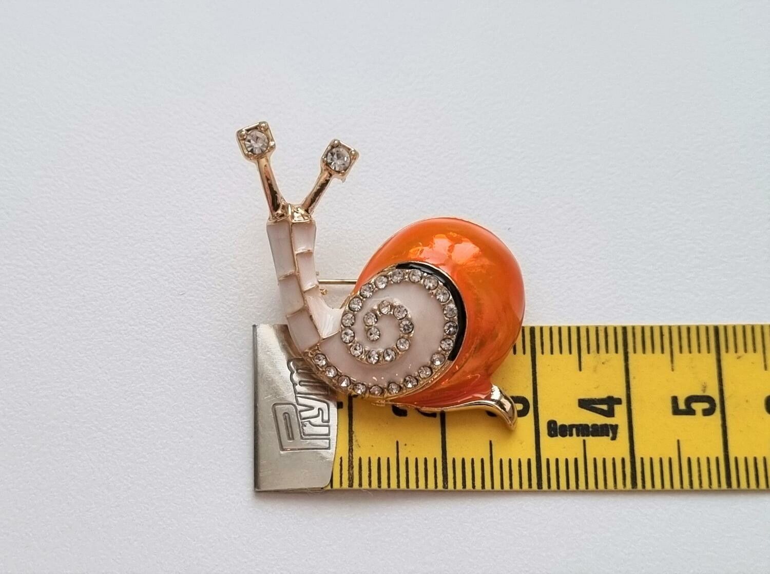 Brosch, gullig liten orange snigel