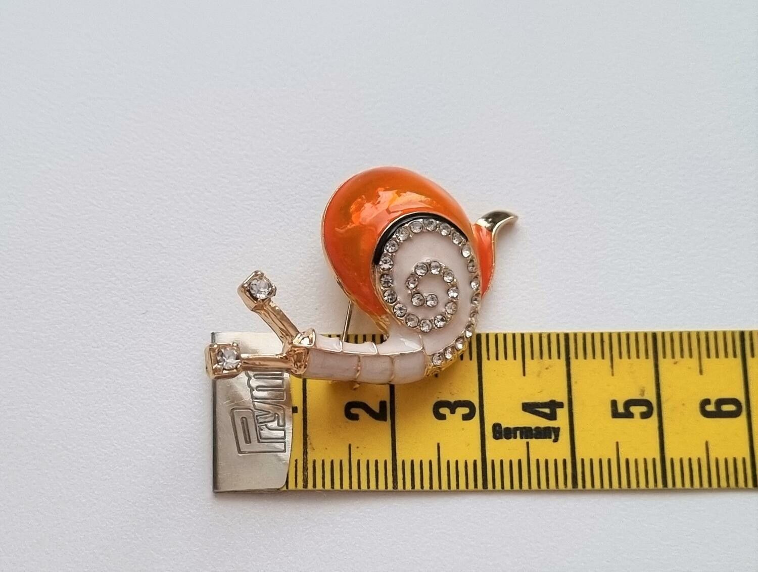 Brosch, gullig liten orange snigel