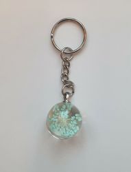Nyckelring Glaskula glasboll med torkad blomma (turkos)