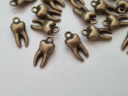 2 st tänder, tandberlocker / charms för smyckestillverkning (bronsfärgade)