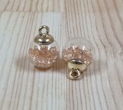 2 st runda glasberlocker, miniflaskor / glasbollar med ögla (beige fyllning)