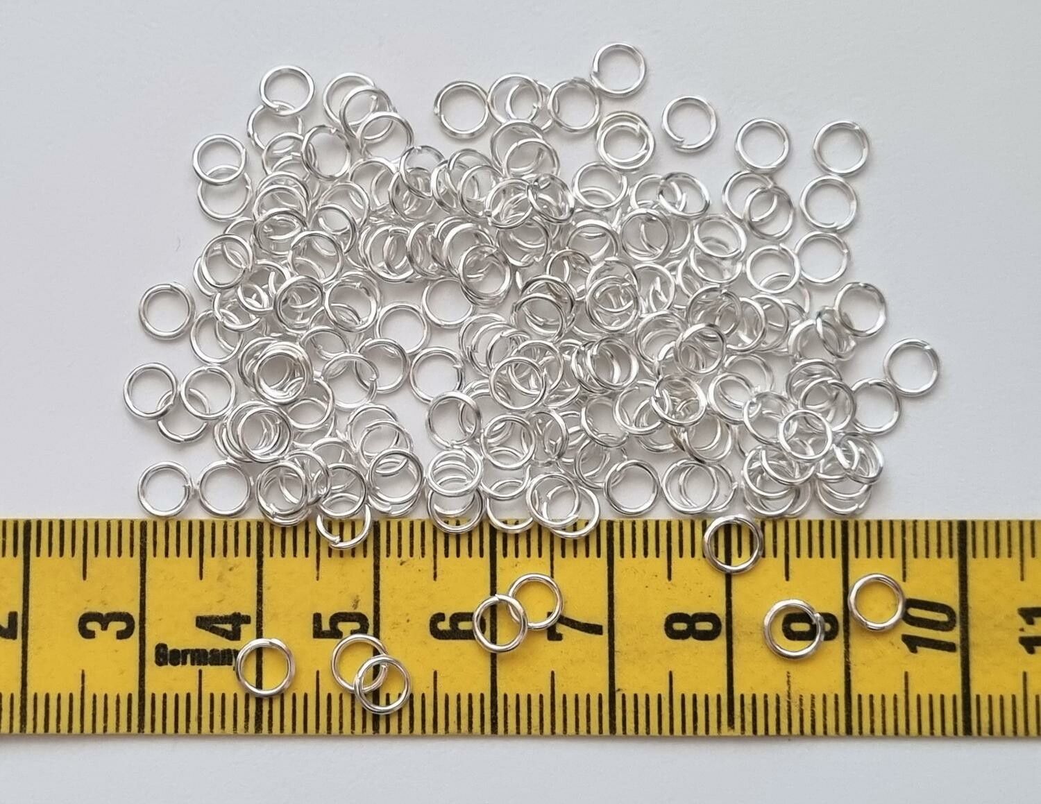 100 st jumprings / bindringar (5 mm, vita/ljus silver)