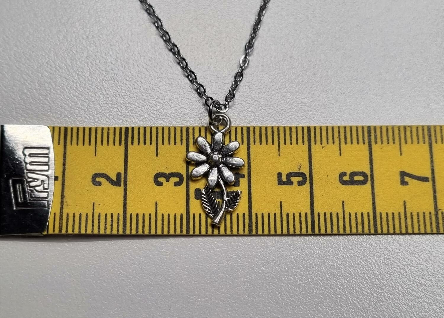 Halsband med en liten blomma, blomberlock / charm