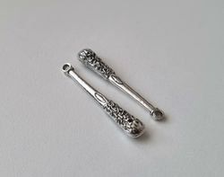 2 st silverfärgade klubbor,. Berlocker / charms