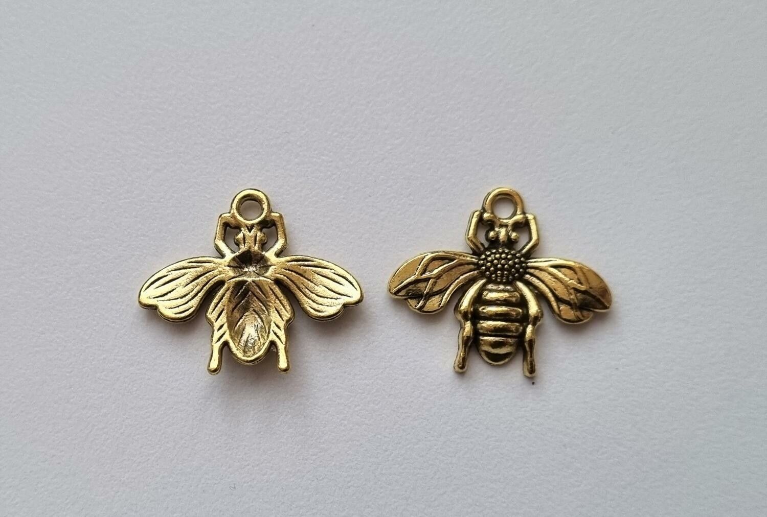 2 st guldfärgade bin,. Berlocker / charms