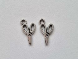 2 st silverfärgade saxar. Berlocker / charms
