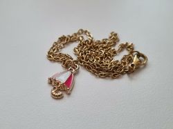 Guldfärgat halsband med ett paraply / paraplyberlock