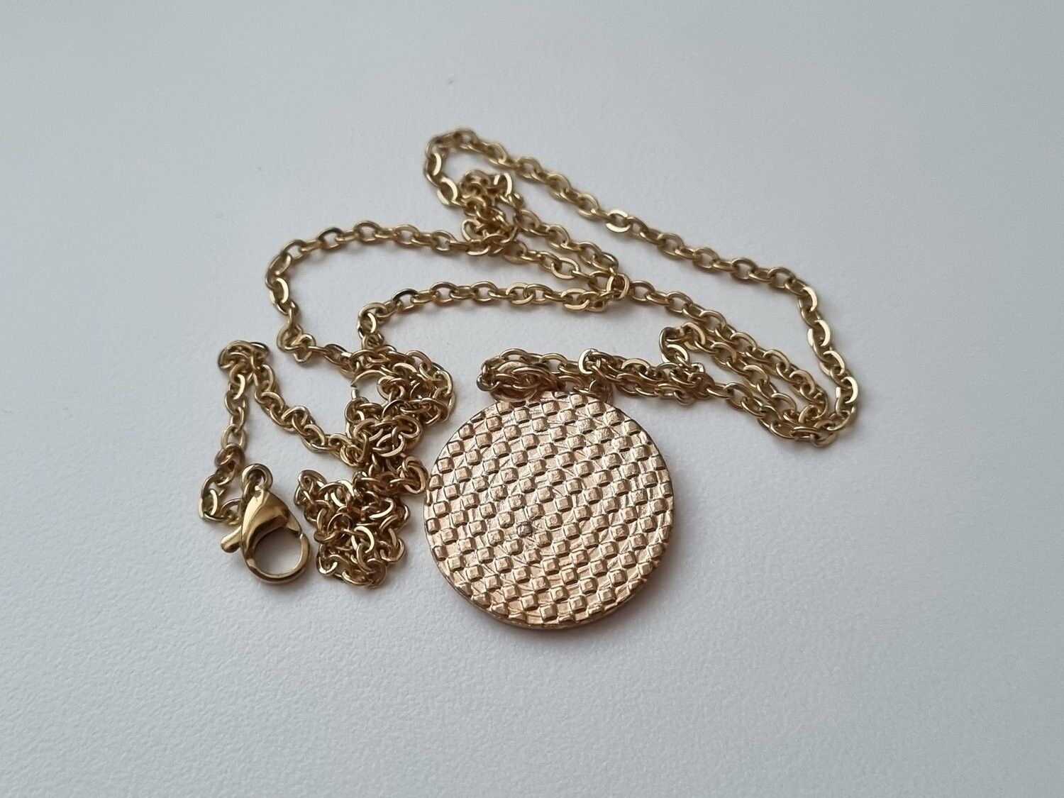 Guldfärgat halsband med en pusselbit / medvetenhet