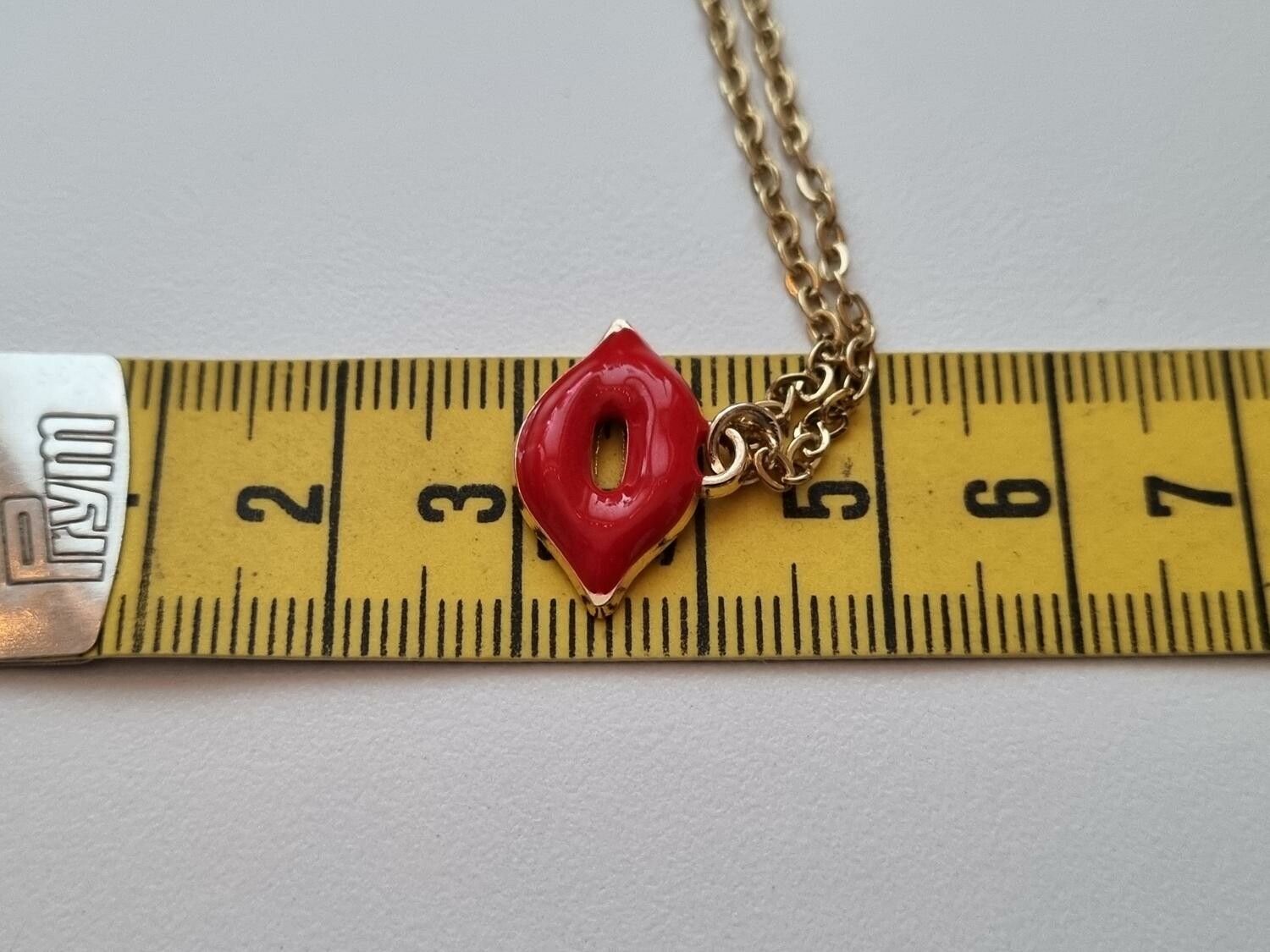 Guldfärgat halsband med en mun / munberlock
