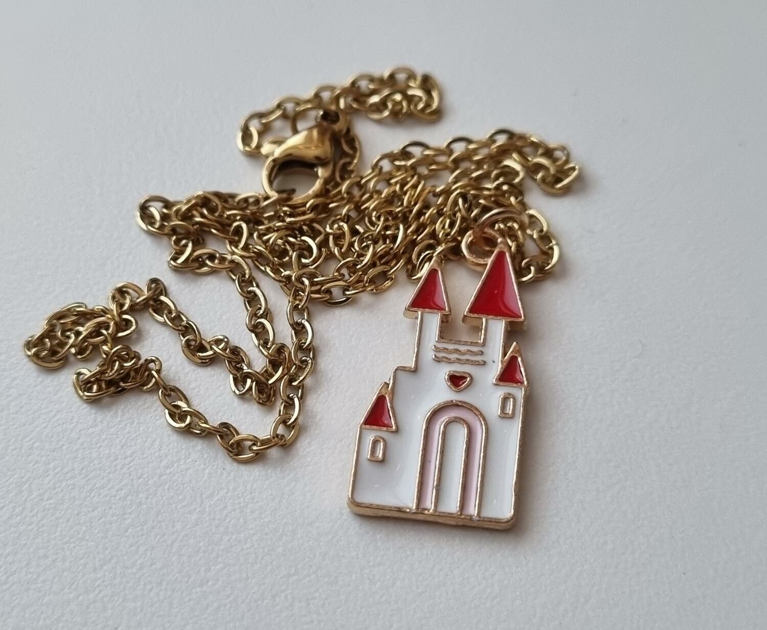 Guldfärgat halsband med ett slott