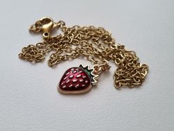 Guldfärgat halsband med en jordgubbe