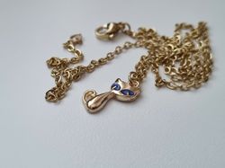 Guldfärgat halsband med en katt