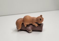 Ekorre på en stock. Miniatyrer för dekoration, tittskåp / dockskåp