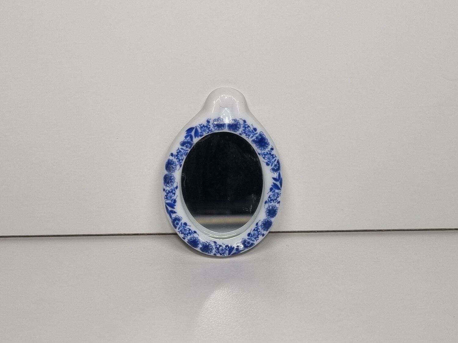 Dockskåpsspegel, miniatyr i porslin