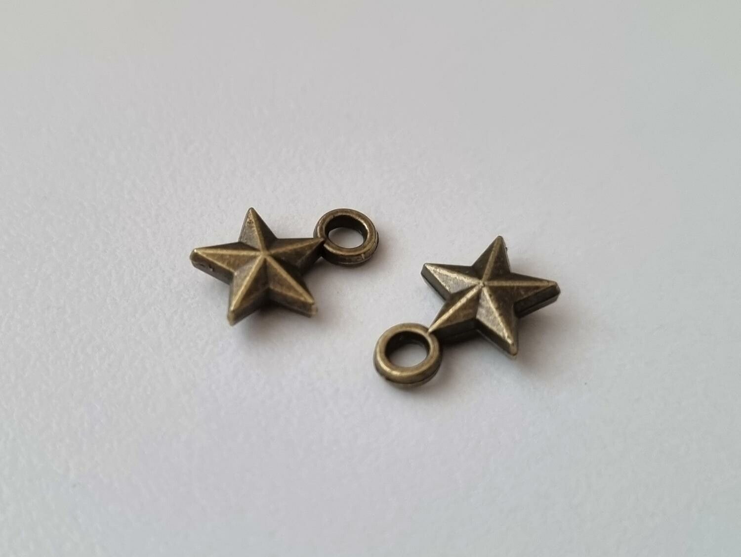 2 st bronsfärgade stjärnor. Berlocker / charms / hängen