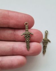 2 st små bronsfärgade svärd / minisvärd. Berlocker Charms