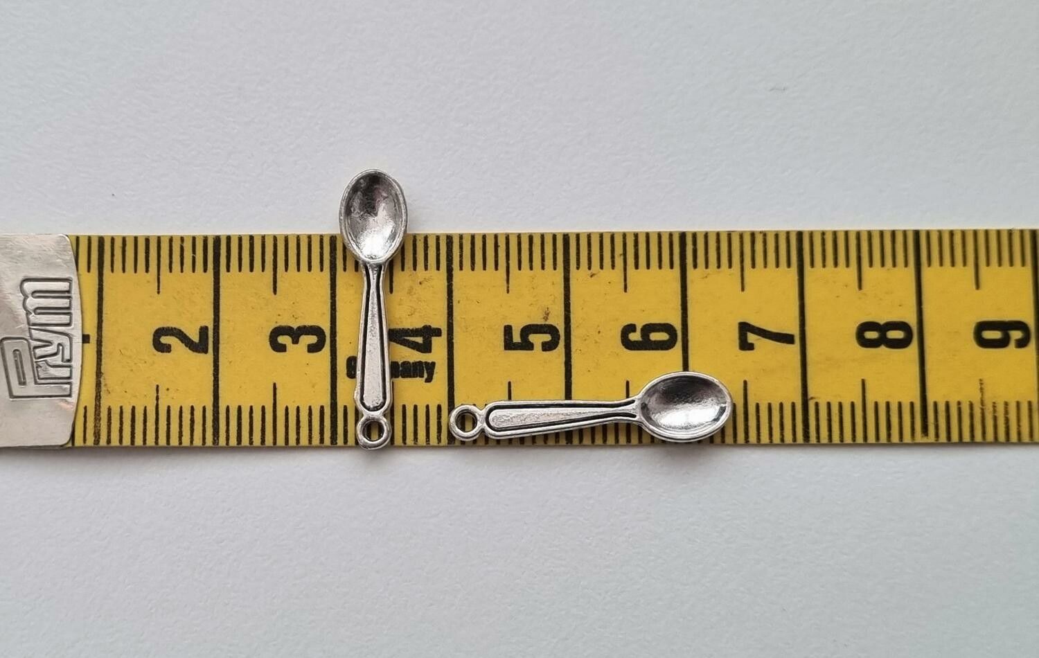 2 st silverfärgade skedar. Berlocker / hänge / charm