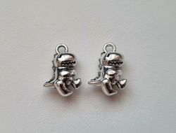 2 st Dinosaurier. Berlocker / charms / hängen