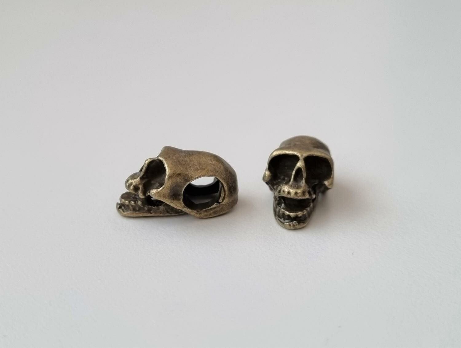 2 st bronsfärgade dödskallar. Hängen / berlocker / charms / miniatyrer