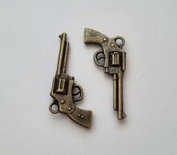 2 st bronsfärgade revolvrar / pistoler. Berlocker / charms / miniatyrer