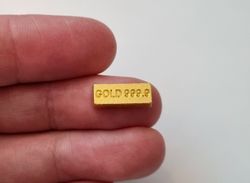 1 st leksakspeng / låtsaspeng som föreställer en guldtacka, miniatyr