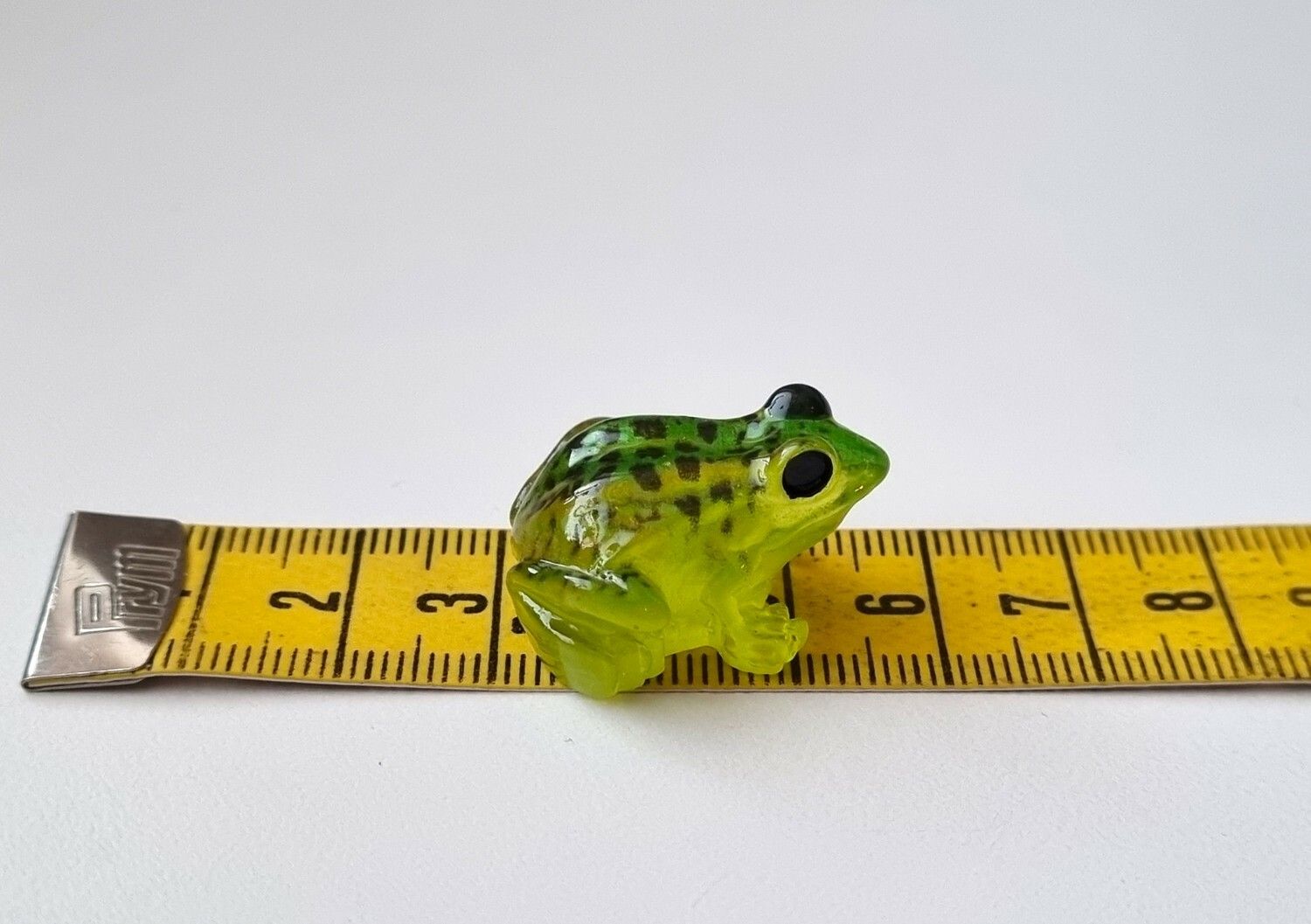 Grön liten groda. Miniatyr för dekoration