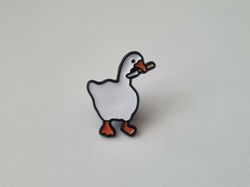 Pins, anka / gås med en kniv i munnen
