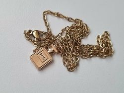 Halsband med en vit parfymflaska