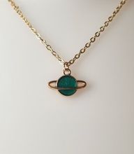 Guldfärgat halsband med en grön planet, berlock / charm