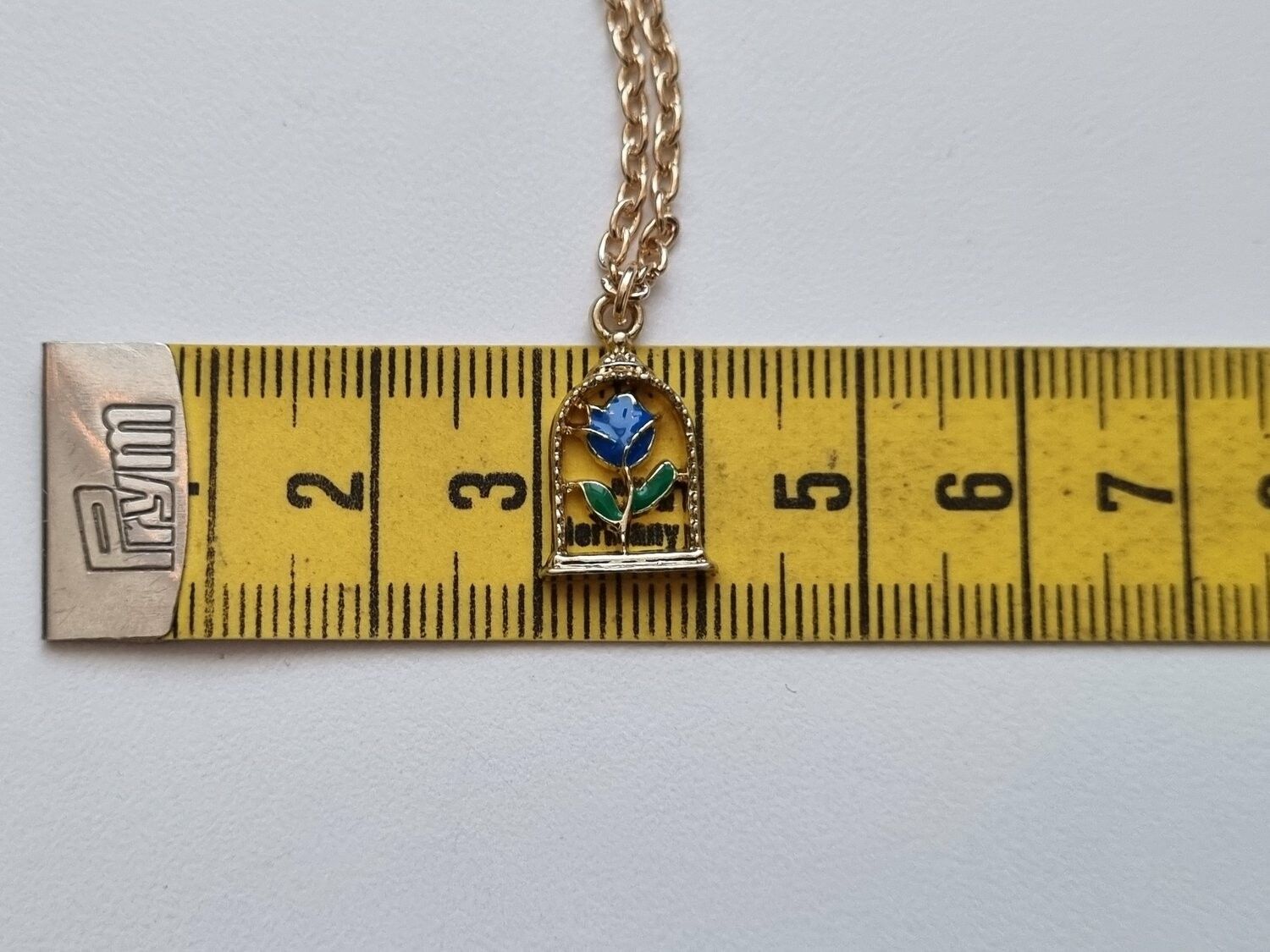 Halsband med blå ros i bur