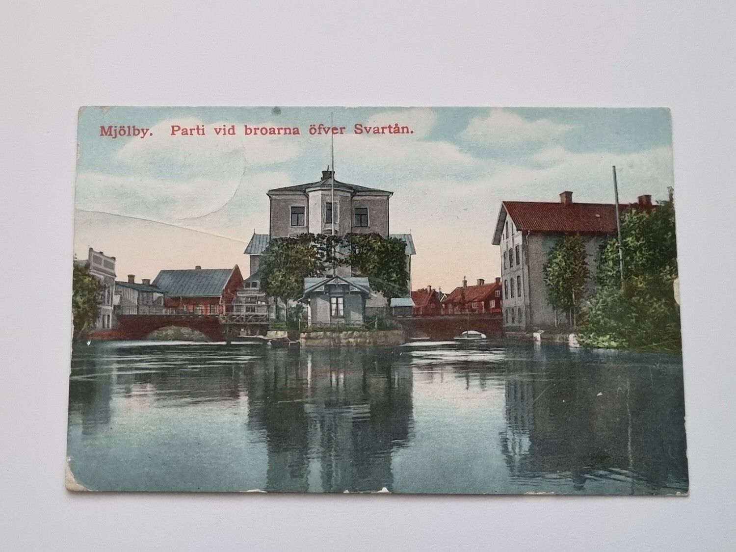 Vykort Mjölby. Parti vid broarna öfver Svartån, 1912