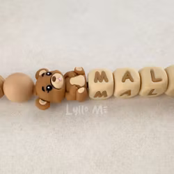 Pacifier holder with name NALLE Hazelnut /WHEAT