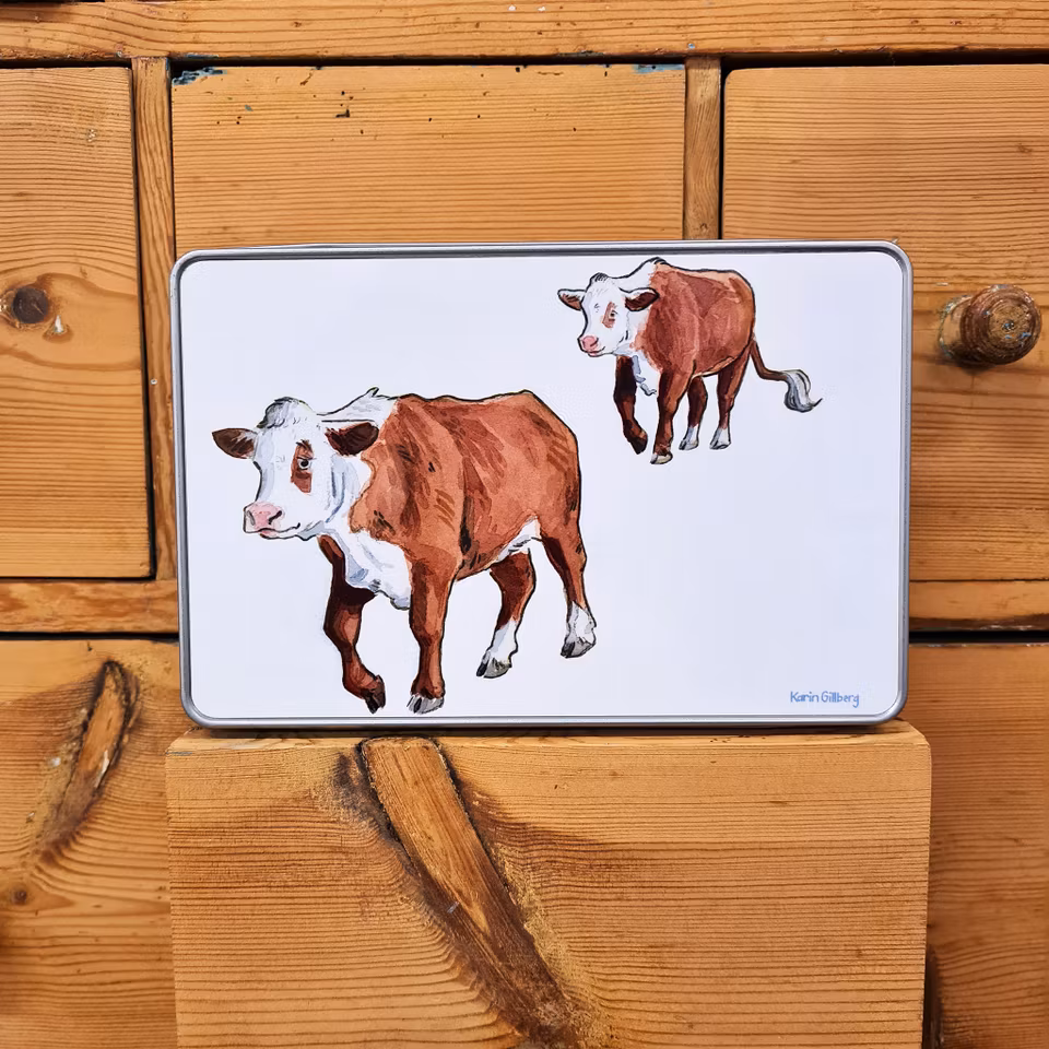 Burk med motiv av två kor som går.