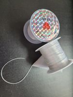 54 Elastisk platt fibertråd vit