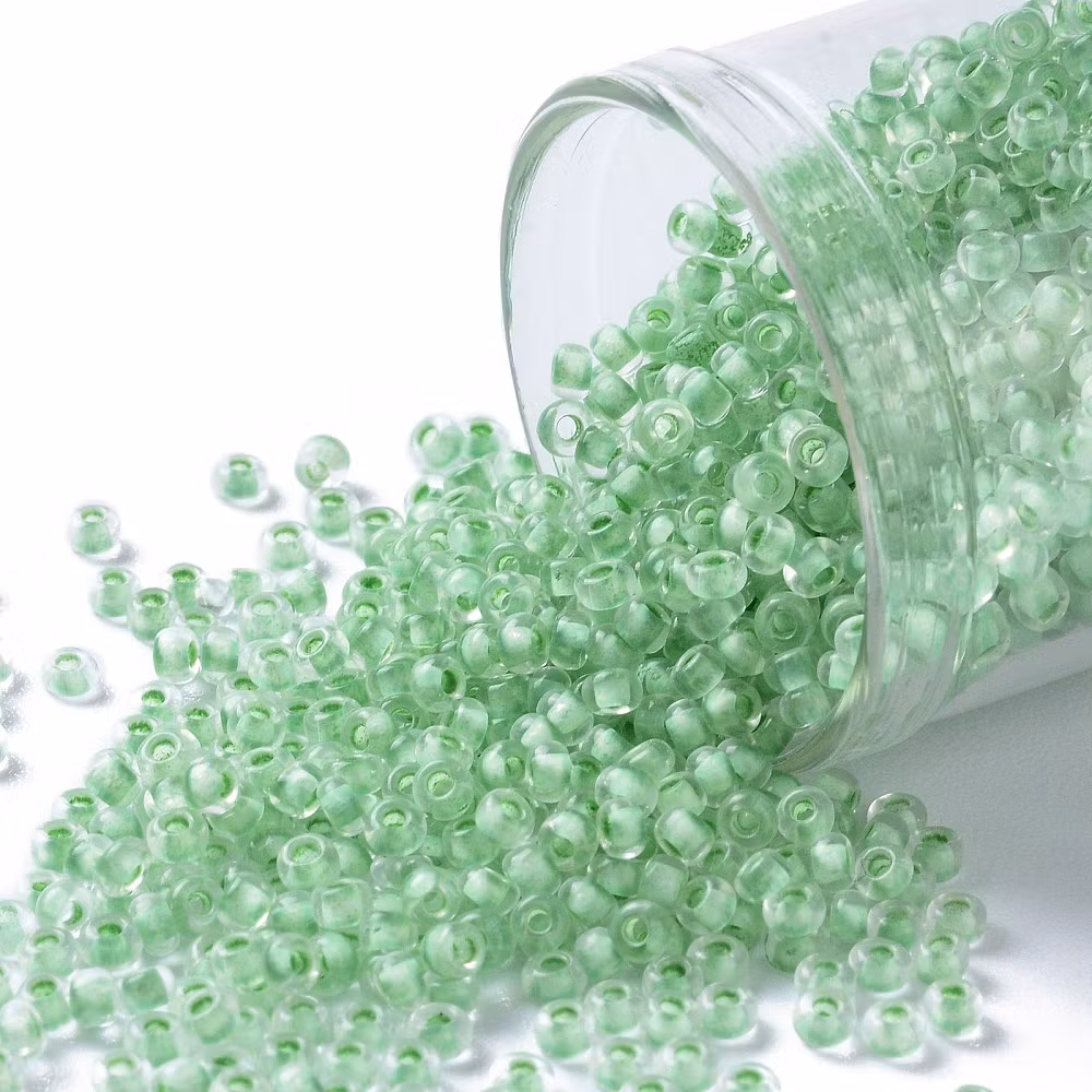 Toho 11/0 ( 975 ) inside color crystal/neon sea foame lined 11/0, 10gram